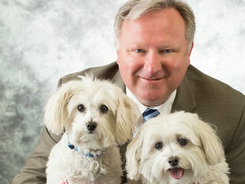 A man who takes his work home with him. Rob Blizard, Norfolk SPCA executive director, with his adoptees Holly and Ginger.