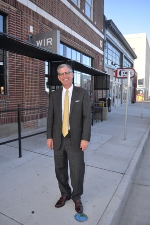 Brother Rutter walks along Granby street outside of the revitalized Texaco Building