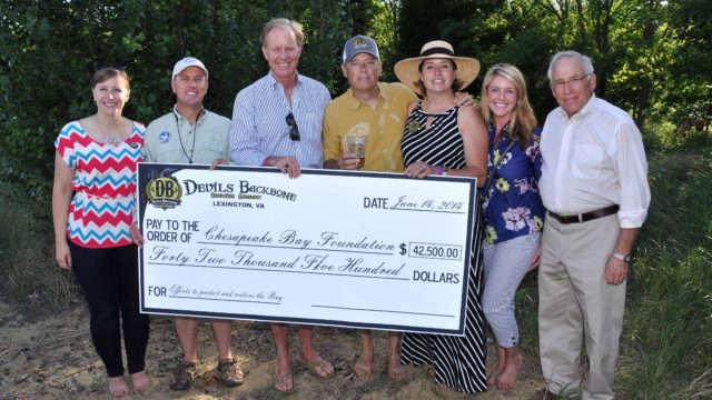 (Members from the Chesapeake Bay Foundation receive a ceremonial check from Devils Backbone Brewing Company)